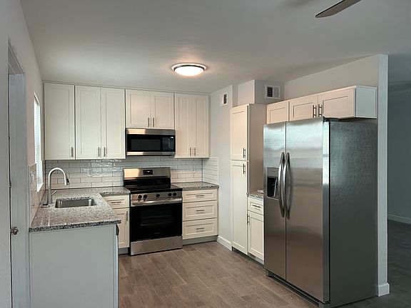 Newly updated bright kitchen with granite counter tops, new counter depth refrigerator with icemaker, new above the range microwave, new glass top stove, new dishwasher.