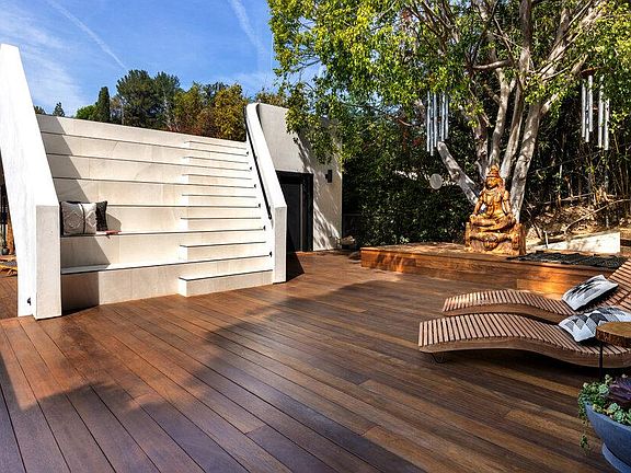 Large theater style stairs case leading to massive roof deck perfect for hosting gatherings and watching the stars at night.