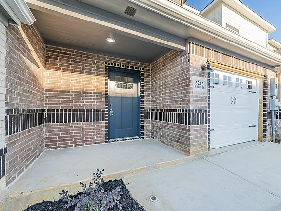 One car garage with additional parking behind garage door.