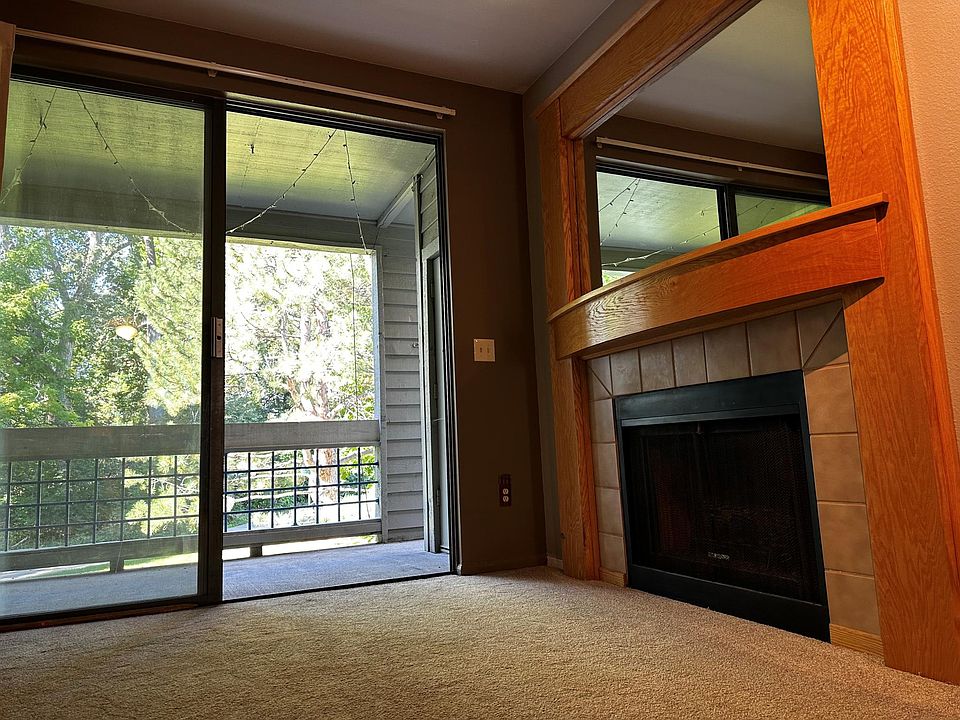 Living room with slider, large deck and gas fireplace