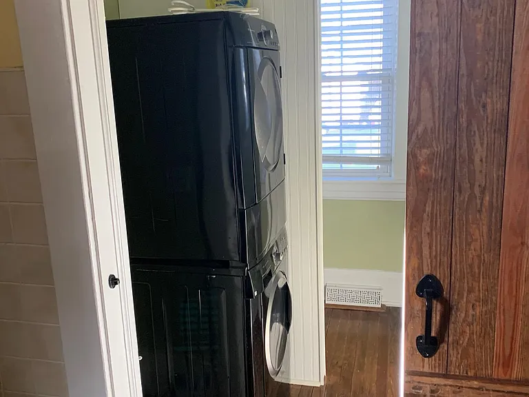 Entry to half bath from kitchen. Full size stacked washer and dryer in the half bath.