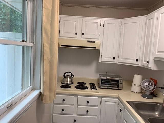Kitchen with cooktop, spacious cabinets, countertop convection/toaster oven.