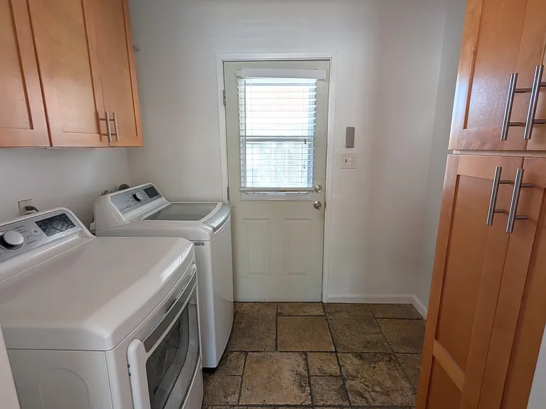 Laundry room with washer and dryer, storage