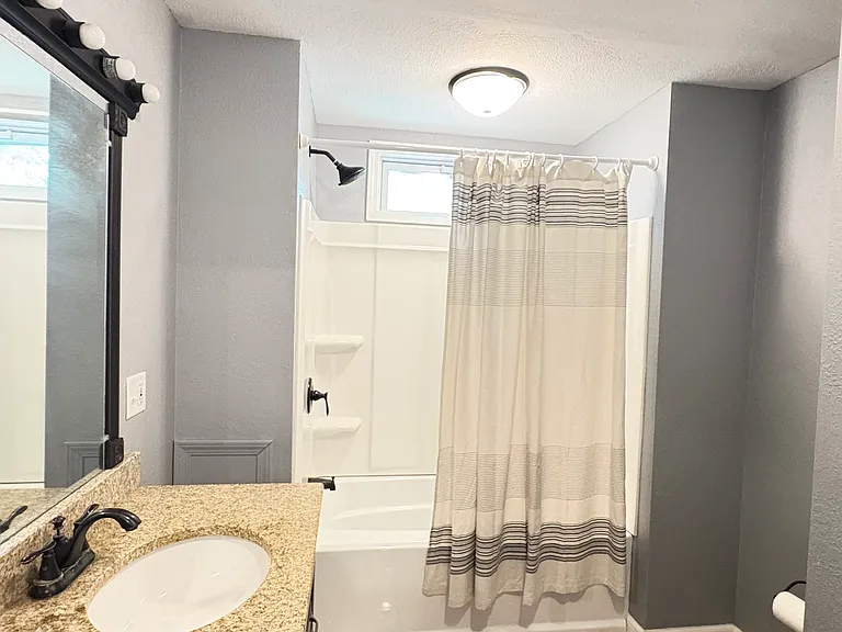 Spacious bathroom with ample storage and cabinet space.
