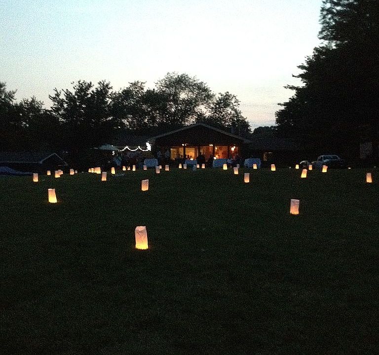 House from lake. Lit up yard