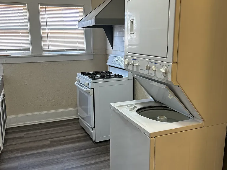 Kitchen looking at the stove and laundry center (washer/dryer)
