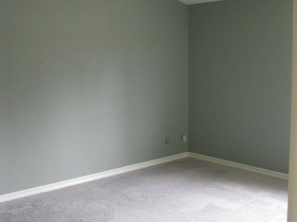 Sunny master bedroom with vaulted ceiling.