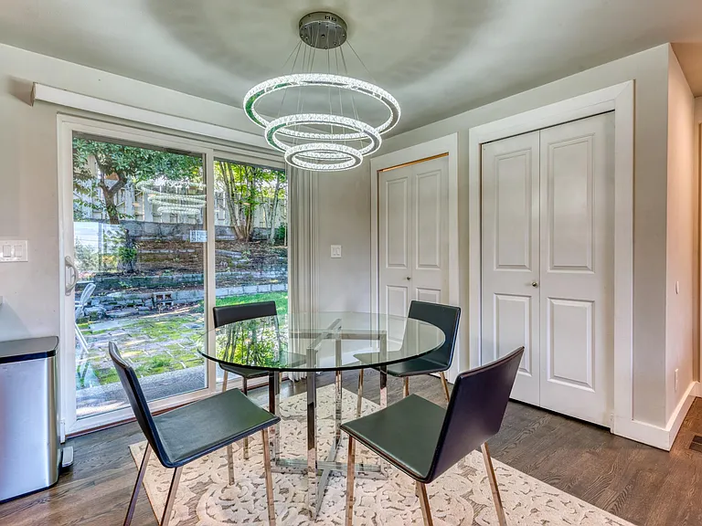 Modern dining area with pantry closet and stacked washer and dryer