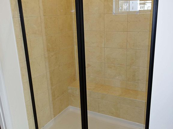 Master shower with bench and custom tiles