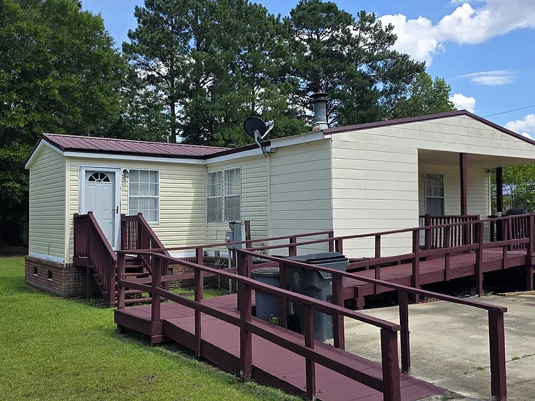 View of side porch and office or extra room space, and entry ways into house