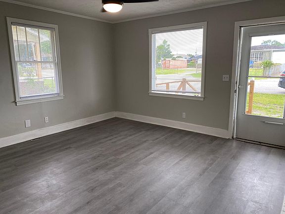 Bright, spacious living room with lots of light and new ceiling fan