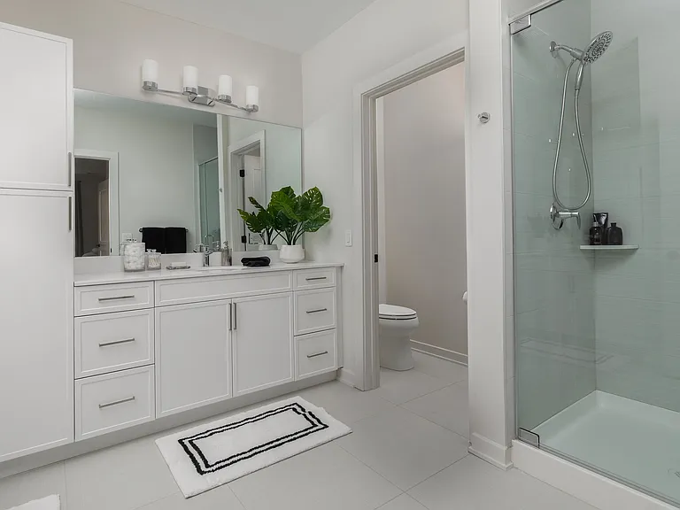 Experience elegance in this modern bathroom with a private water closet, offering a blend of functionality and style.