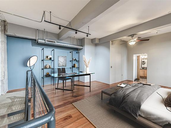 The loft area on the second floor is large enough to hold both a bedroom and office space. This is virtually staged to provide a possible layout.