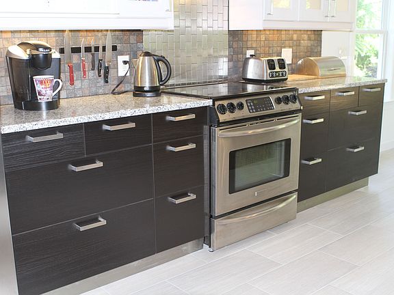 Dark brown base cabinets with soft close drawers.