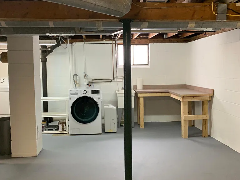 Laundry area with washer, dryer, shelves, and counter for sorting/folding