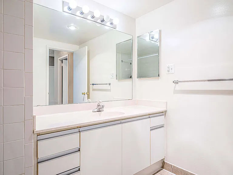Spacious bathrooms with large vanity and storage spaces