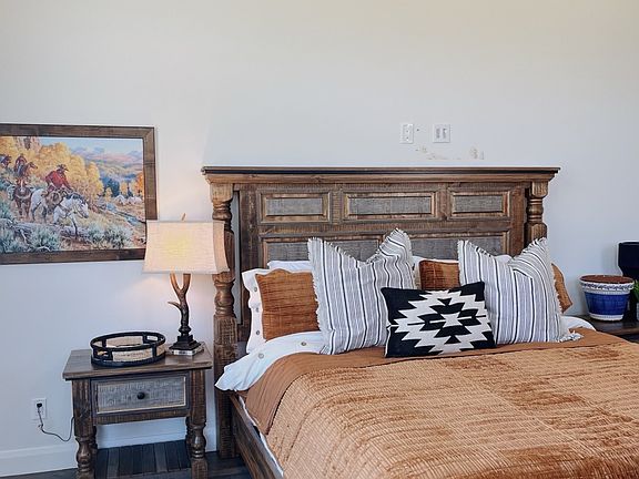 queen bed with nightstand, accent chair, tv, bedding and a large closet, private lock