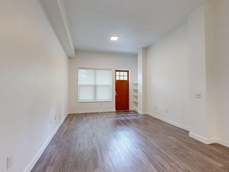 Apartment living room with wood-style flooring.