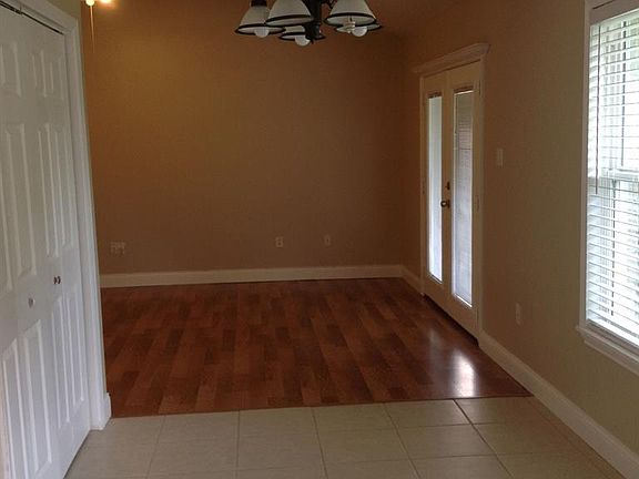 Looking into the den from the kitchen area and through the breakfast room. Pantry is on the left here
