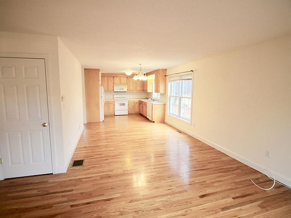 View from family room into kitchen. Hardwood flooring throughout unit.