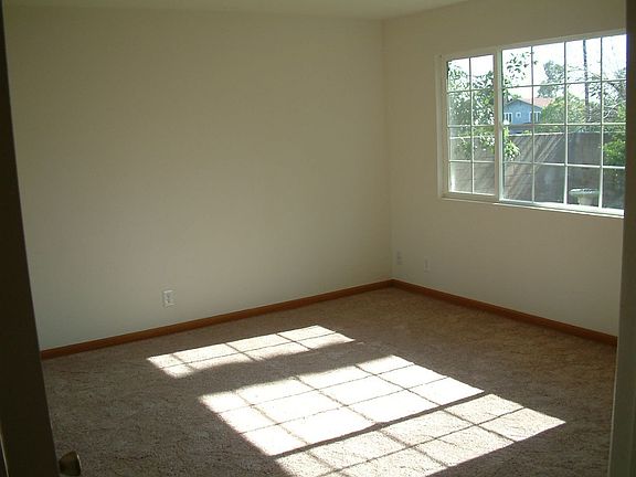 Master suite with mirrored closet doors and plenty of windows.