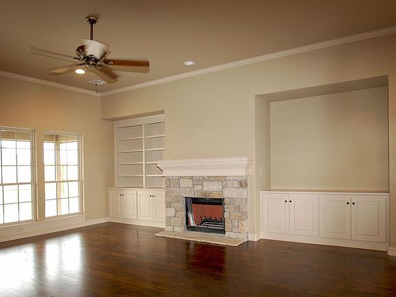 Great Room features stone fireplace, hardwoods & built-ins