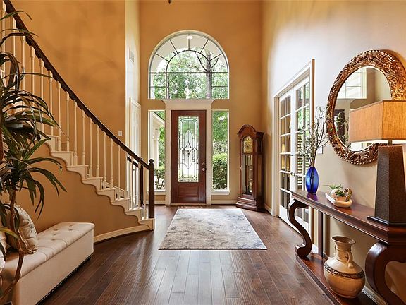 Expansive and bright 2 story foyer has plenty of space for a bench and entry table.