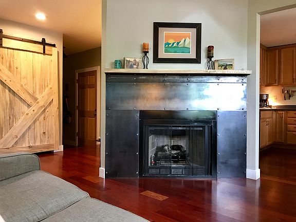 Main living area with gas fireplace (coat closet behind the barn door)
