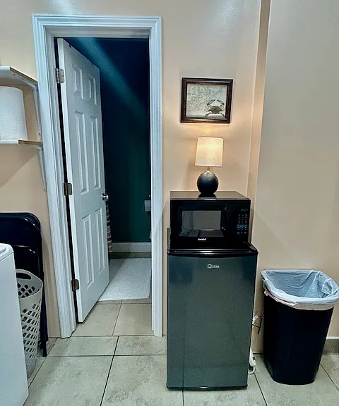 Mini fridge and microwave; entrance to full bathroom