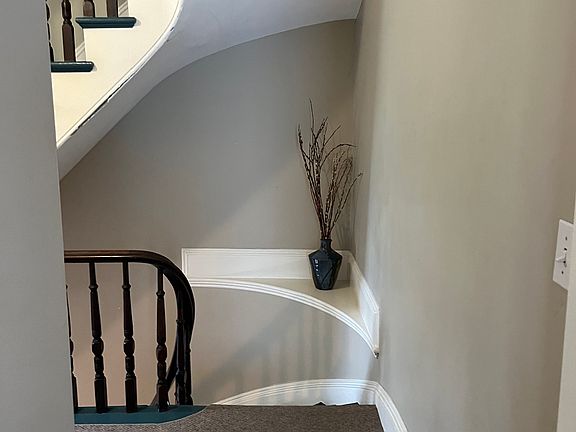 Stairwell leading to second floor landing. coat closet on landing
