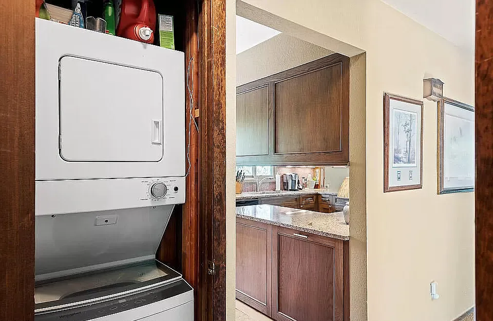 Hallway closet, stackable washer/dryer.