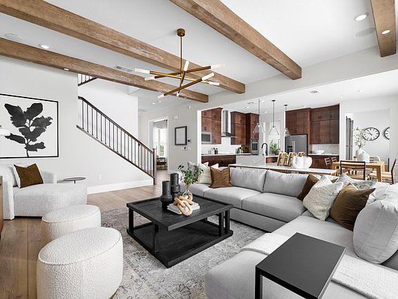 Open gathering area with view of kitchen