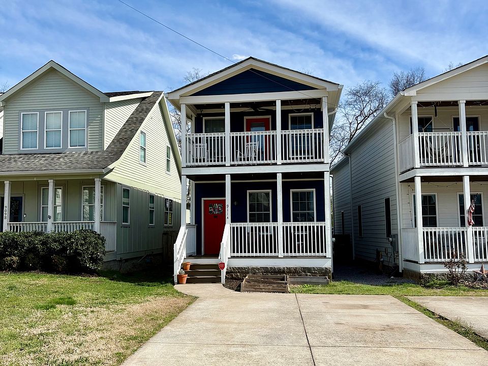 Exterior of home with parking for two vehicles.