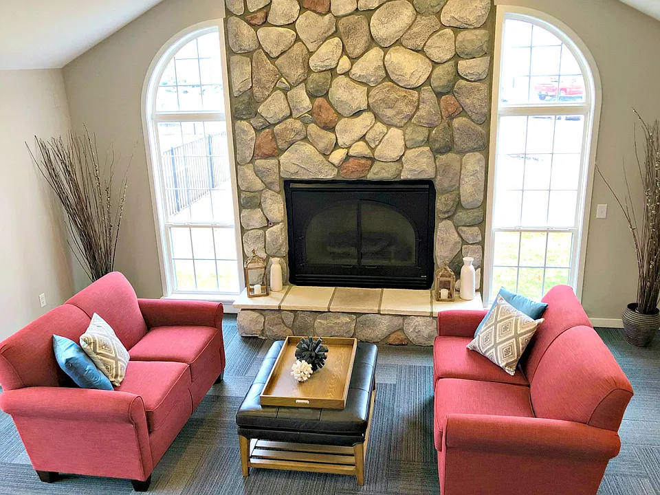 Cozy Clubhouse Fireplace - Fairfield Apartments and Condominiums in Fenton, MI