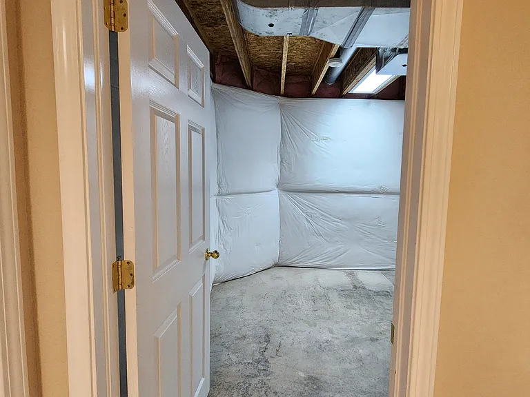 Large, unfinished storage area. Storage area is lighted and insulated.