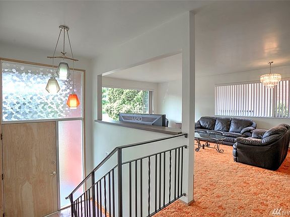 This extra wide entry is a refreshing plus from the typical split-entry homes. NOTE: seller believes there is hardwood floors under the carpet of this living room.