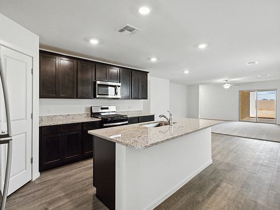 Upgraded kitchen with a large island and stainless steel appliances.