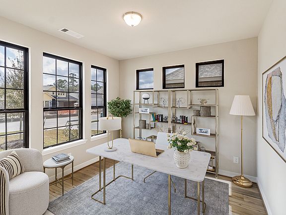 Quietly nestled in front of the home is the study, featuring gorgeous flooring, neutral paint and la