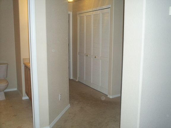 Entryway, half bath and hallway leads to first room