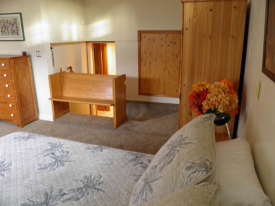 Bedroom and leading down stairs to bathroom, kitchen and office