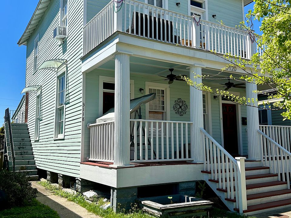 Front of house with Balcony view and private outdoor staircase