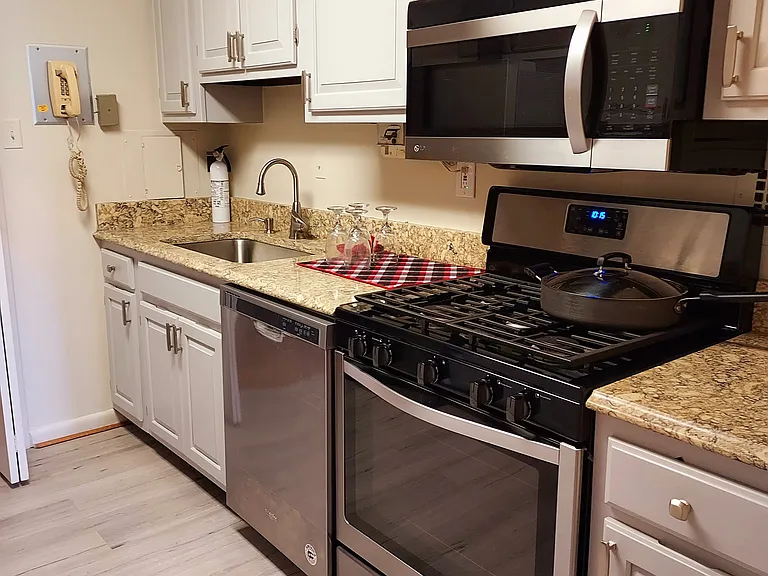 Galley kitchen with food doors and stainless steel appliances.