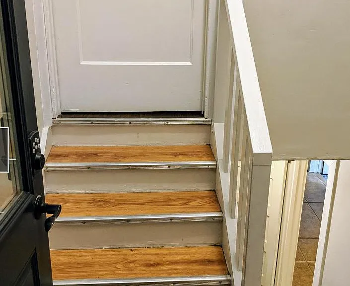 Backyard entrance to property. Stairs leading to upstairs two bedroom apartment