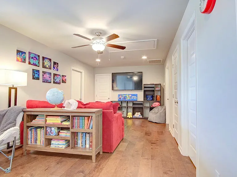 Upstairs loft area with broom closet, storage closet, and walk in attic area above garage