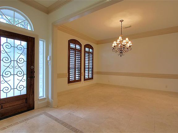 View of Foyer and Dining Room. Note Clear-View Wood Shutters.