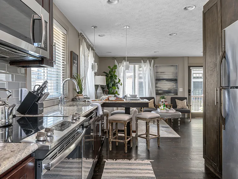 Kitchen has all stainless steel appliances.