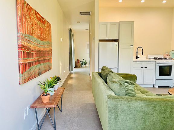 Living room/kitchen (furnished) with hallway towards bedroom/bathroom