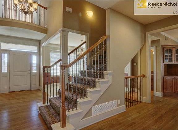 Entry staircase with wrought iron spindles and designer carpet!