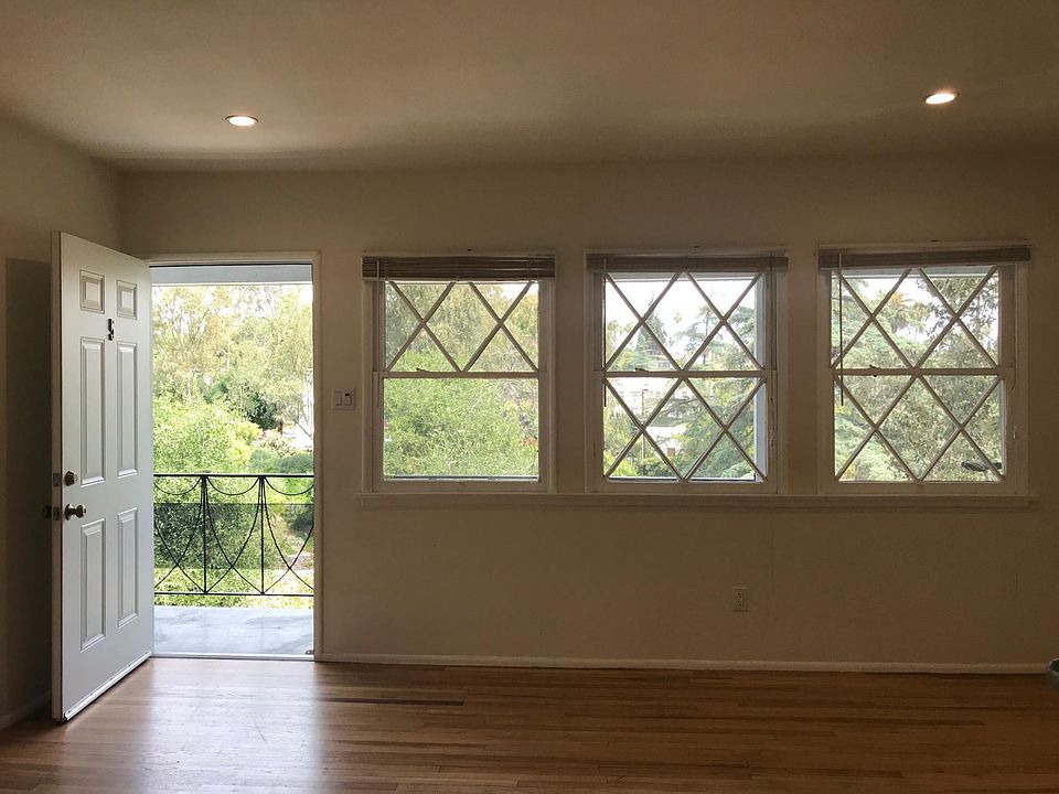 Hardwood floors in the living room with dimmable LED recessed lights *Picture is not of the actual unit but is similar.