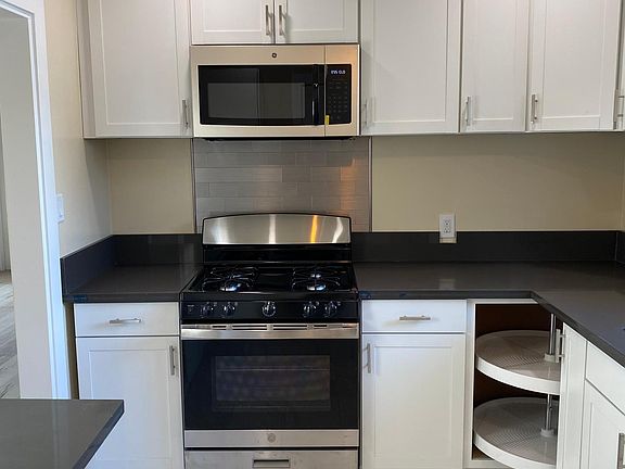 All New Kitchen, Stainless Steel Stove and Lazy Susan with lots of cabinetry.